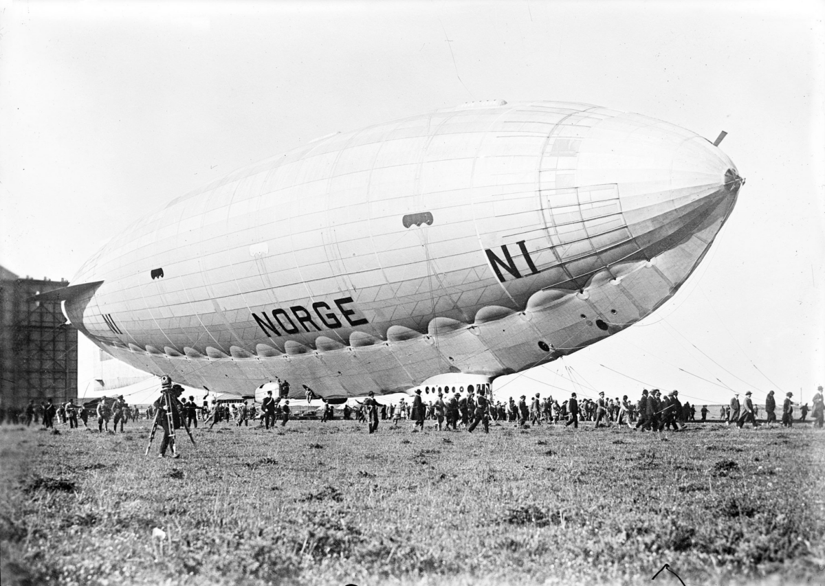 Historic Norge airship surrounded by crowd on field