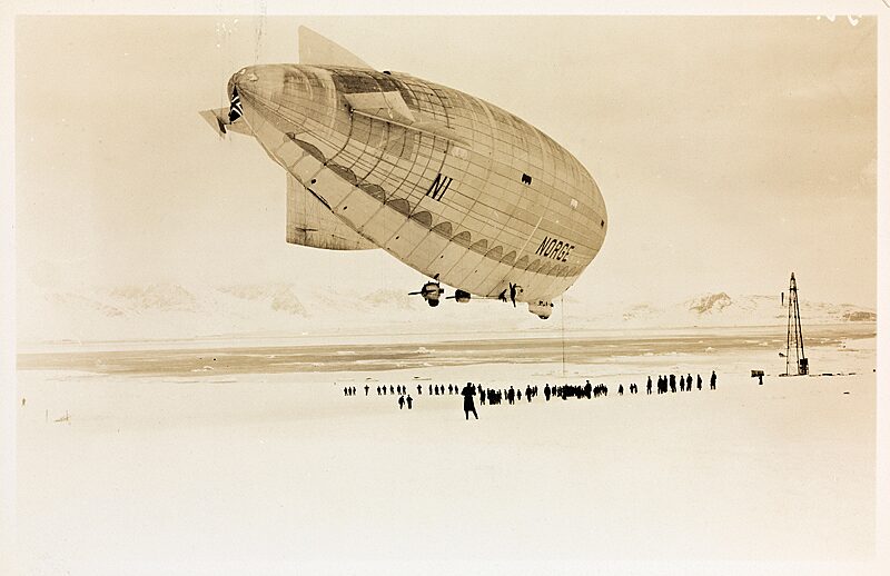 Historic airship flying over snowy Arctic landscape