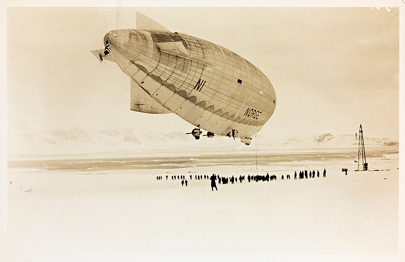 Historic airship flying over snowy Arctic landscape