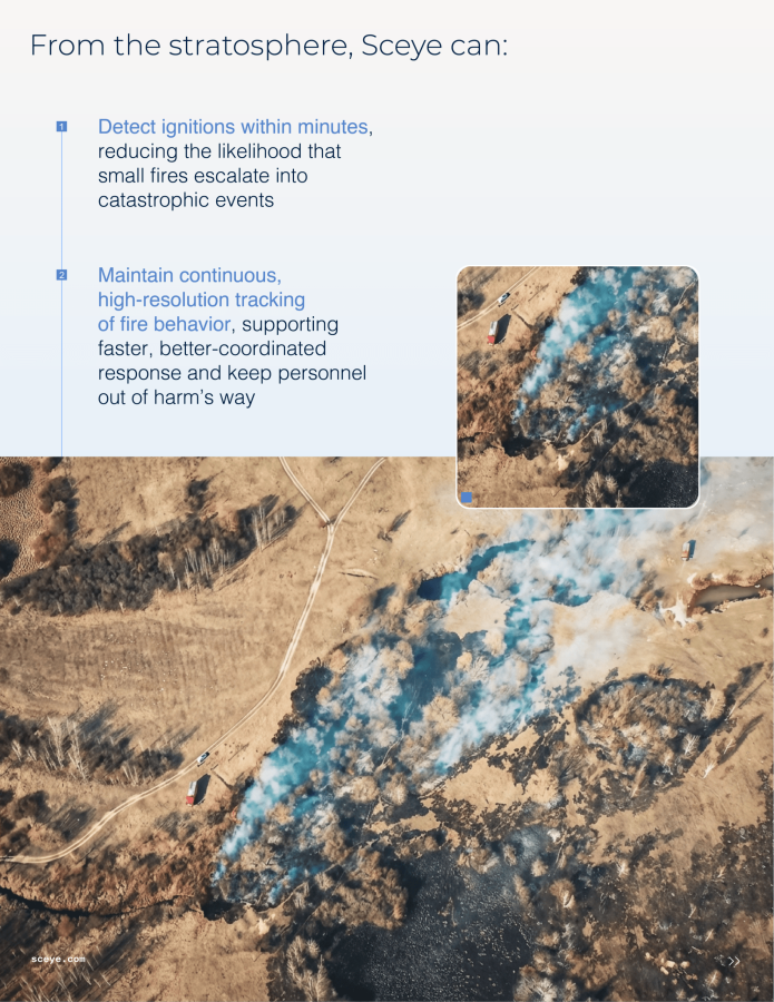 Aerial view of wildfire with smoke and trucks